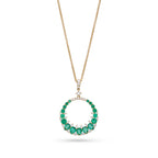 Gold necklace with a Emerald pendant on a white background