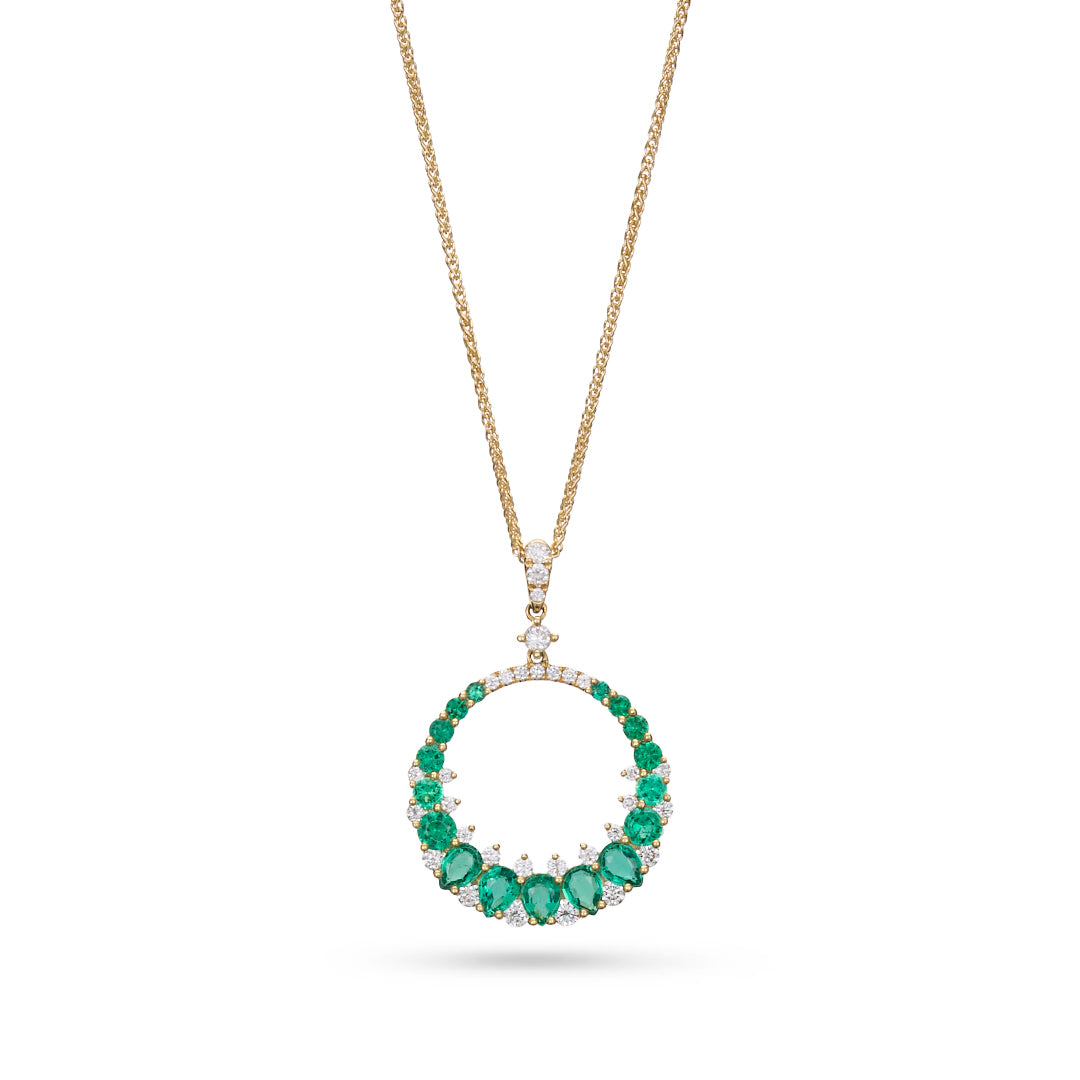 Gold necklace with a Emerald pendant on a white background