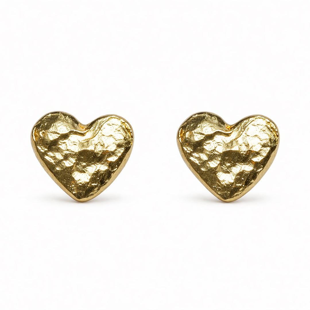 Gold heart-shaped earrings on a white background
